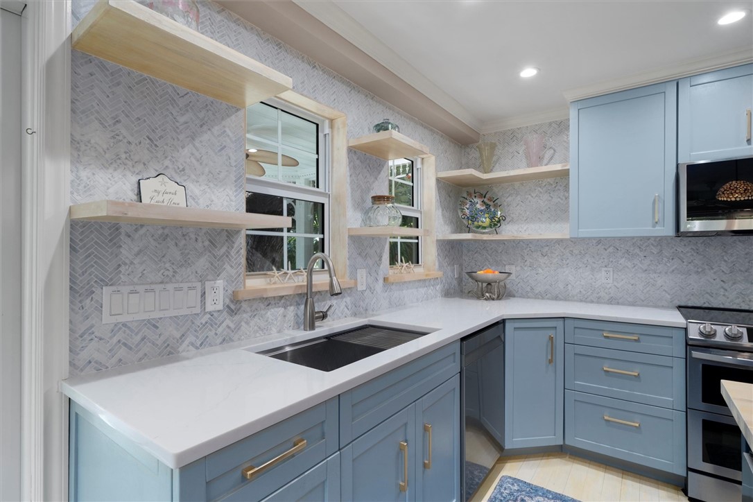 Quartz counter tops and marble herringbone backspl