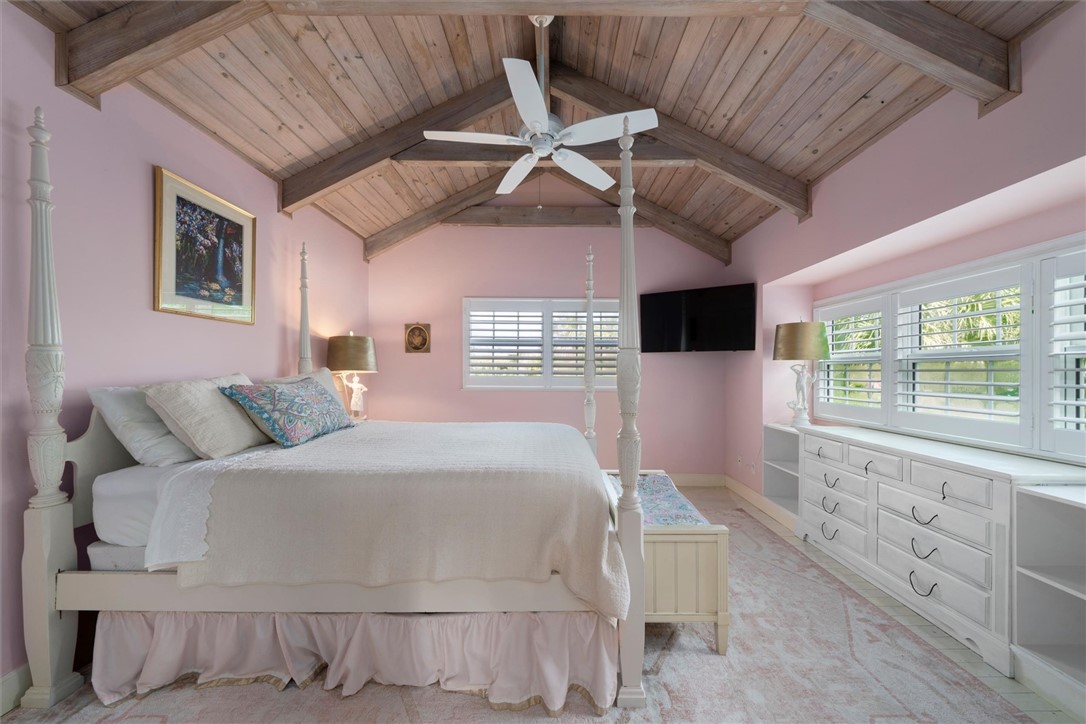 Primary bedroom with vaulted wood beam ceiling