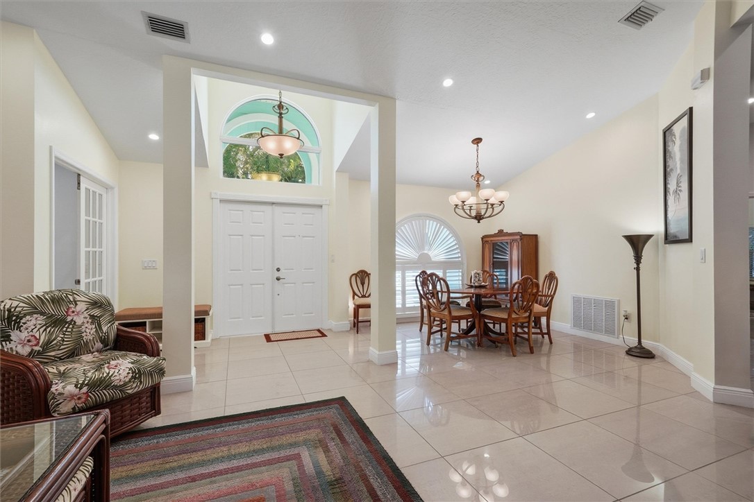 Foyer with vaulted ceiling and marble tile floorin