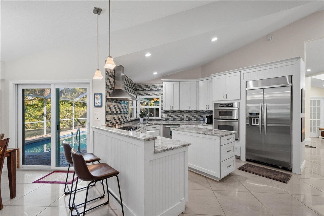 Kitchen featuring vaulted ceiling, a center island