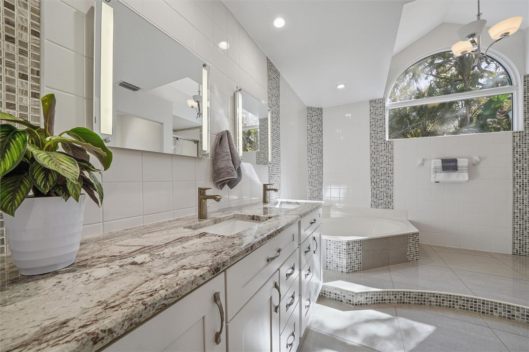 Primary bathroom with garden tub with decorative t