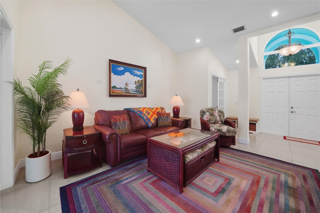 Formal living room with impact slider to pool area