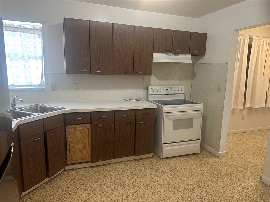 Kitchen with range with electric cooktop, light co
