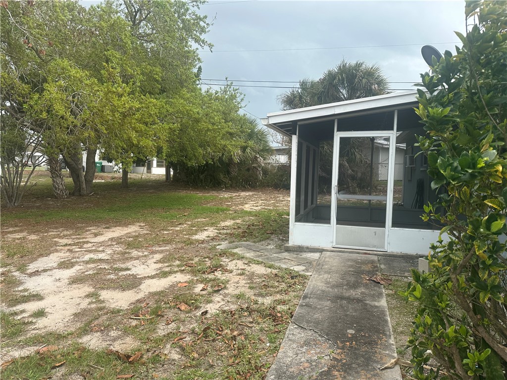 View of yard with a outdoor screened porch