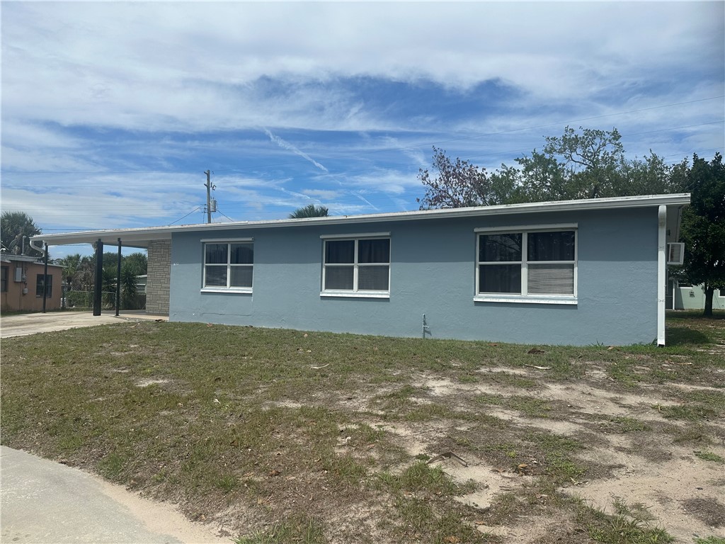 View of side of home featuring an attached carport