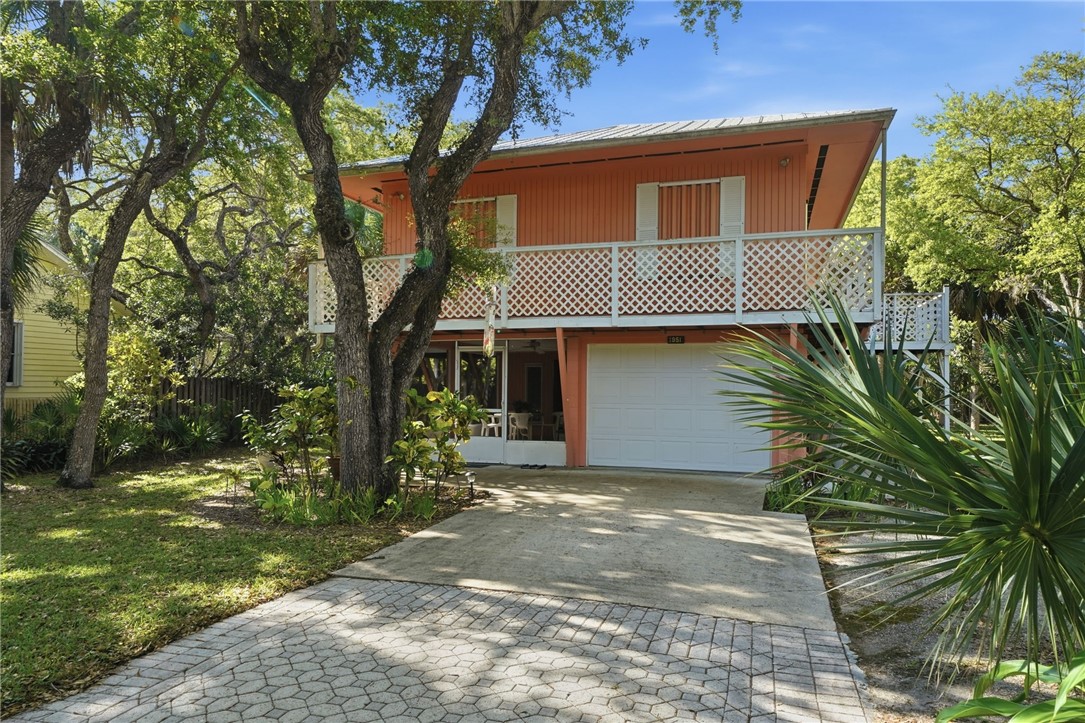 2 story with metal roof and paved driveway