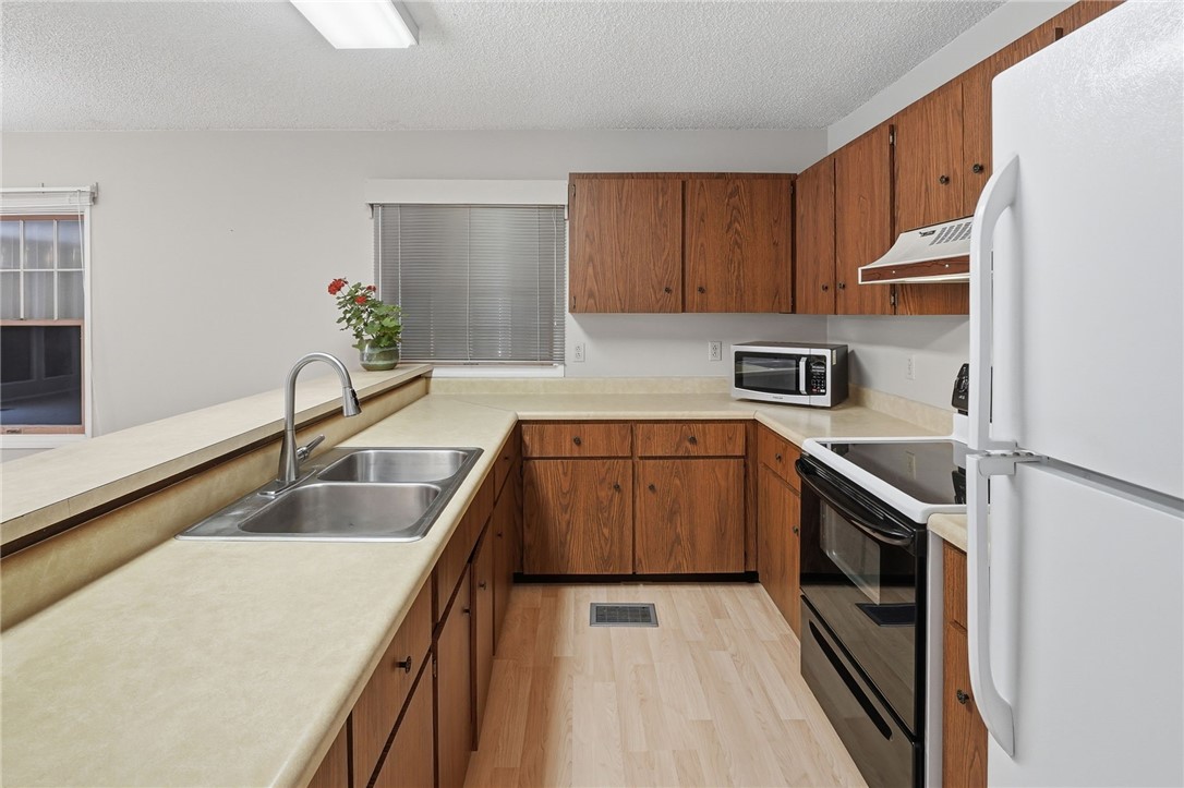 Galley kitchen with wood flooring