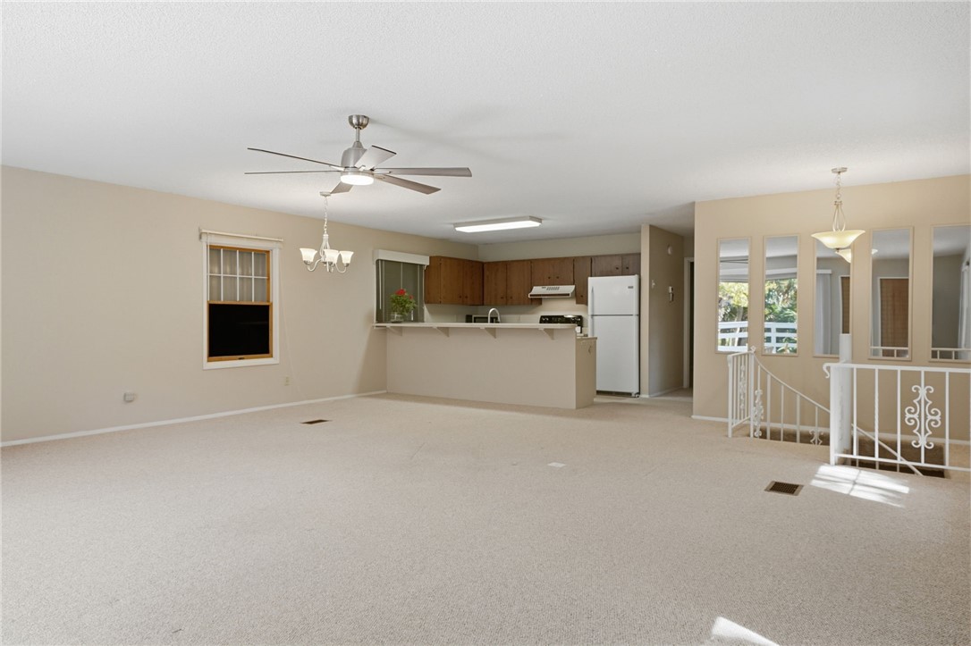 Entrance from spiral staircase to open concept liv