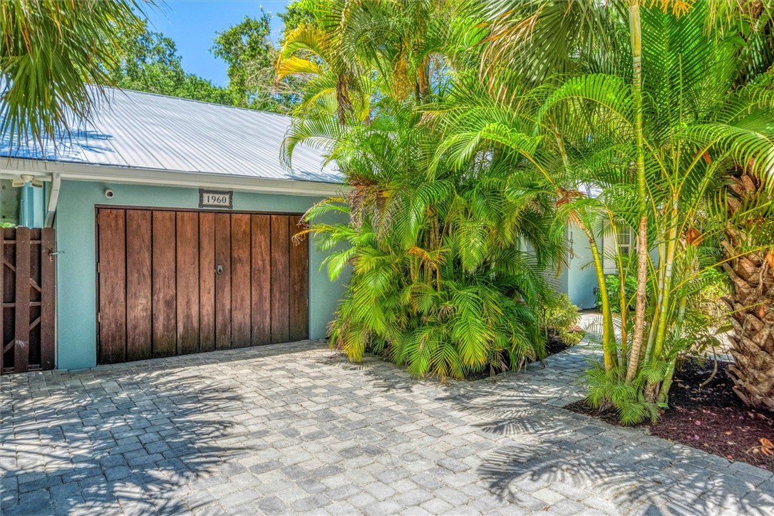 Wood finished storage area with a paver driveway