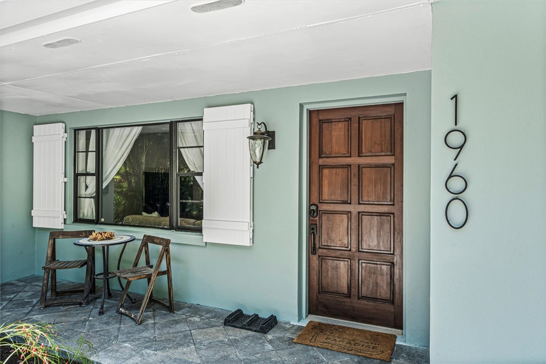 Covered front entry featuring a paneled wood door,