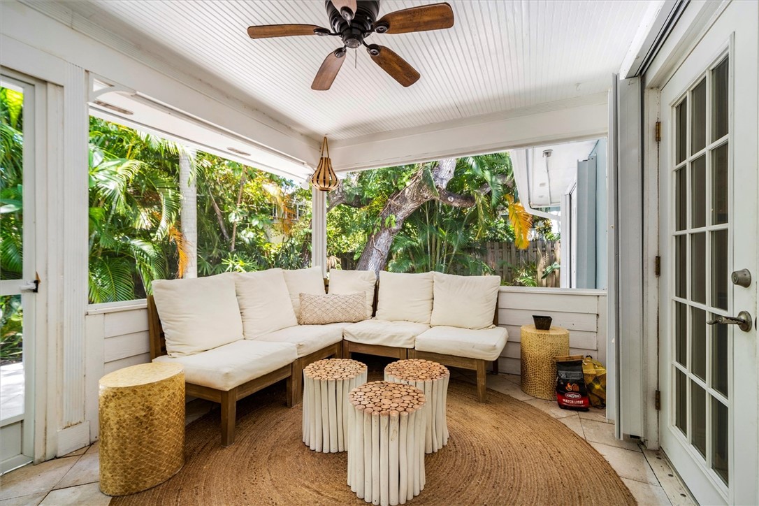 Screened-in porch featuring a beadboard ceiling wi