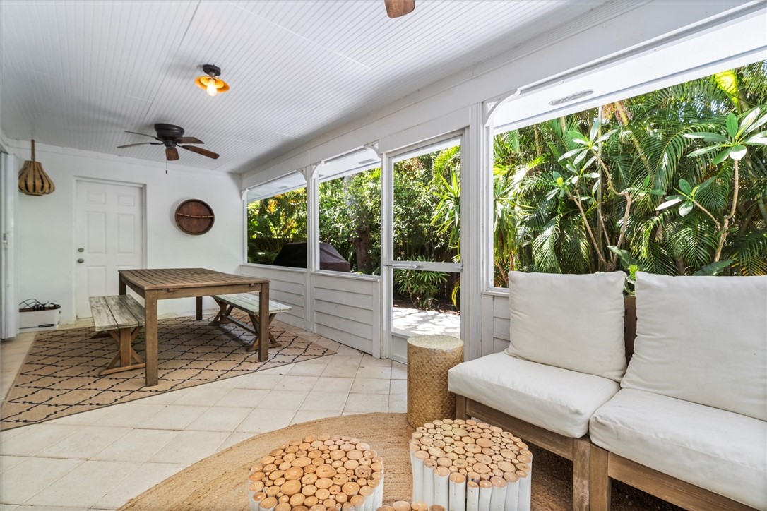 Spacious Screened porch featuring white paneled wa