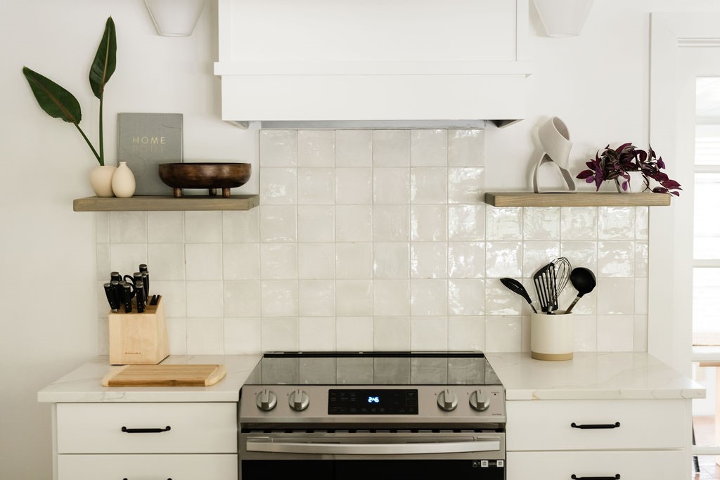 Stainless steel range with a white tile backsplash