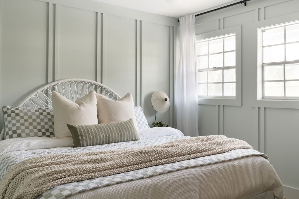  Bedroom featuring accent wall with vertical panel