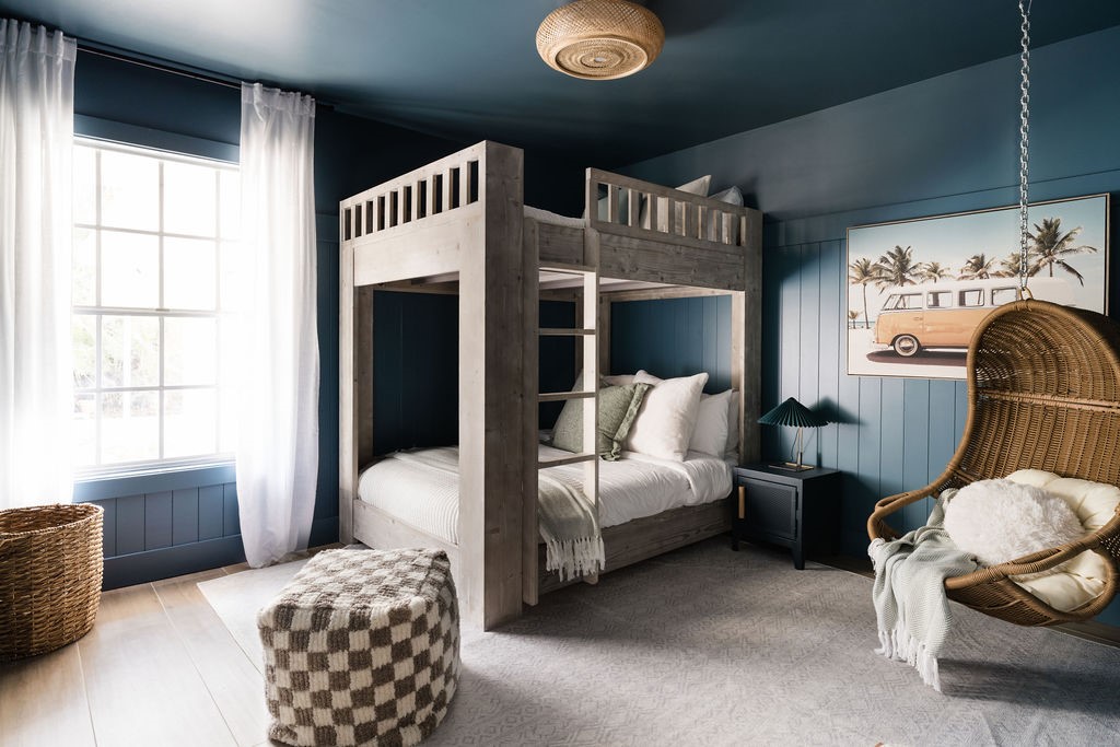 Bedroom featuring paneled wall and gestured ceilin
