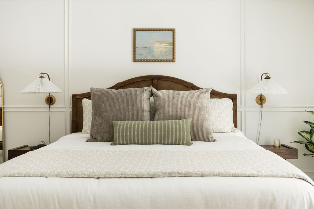 Primary bedroom with panel molding accent wall wit