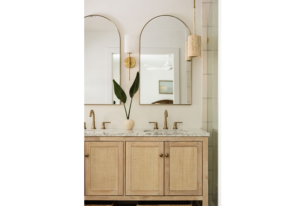 Double vanity with light wood-finish cabinetry and