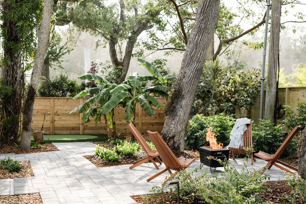 Paved patio area featuring a fire pit, surrounded