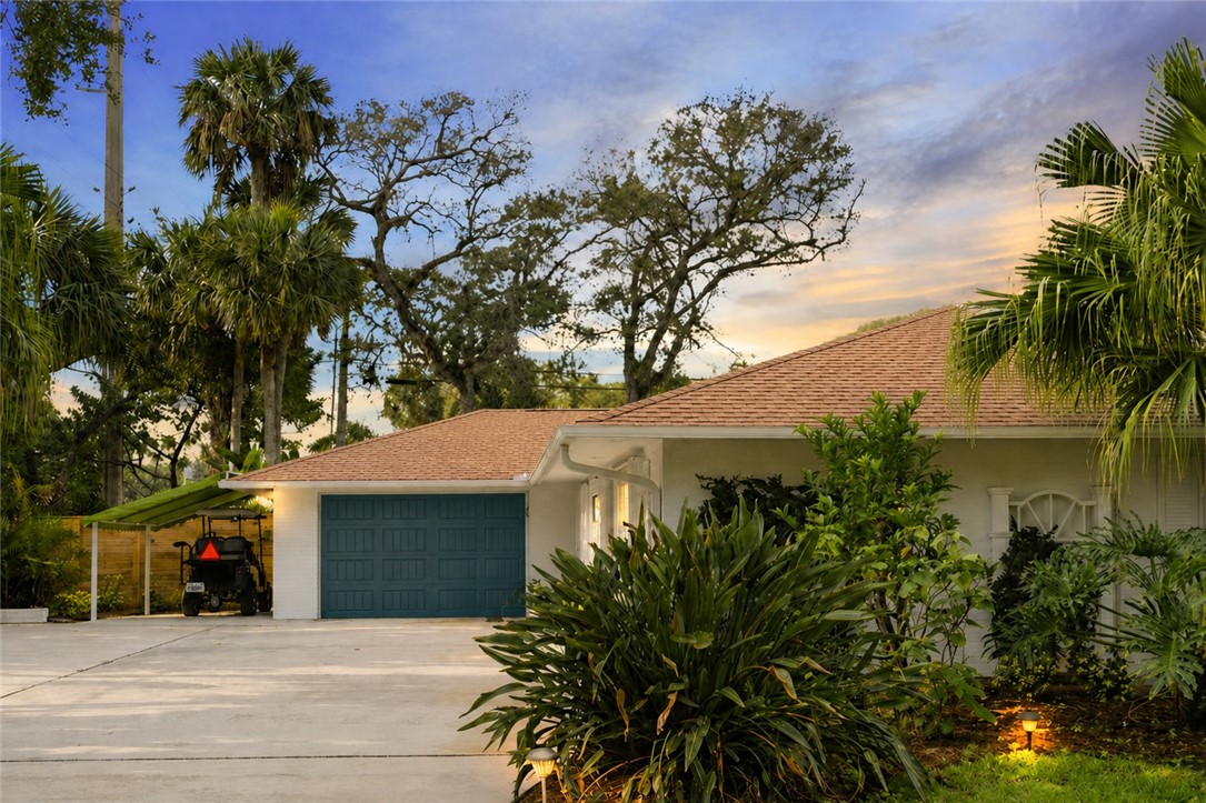 Exterior featuring a teal garage door, attached ca