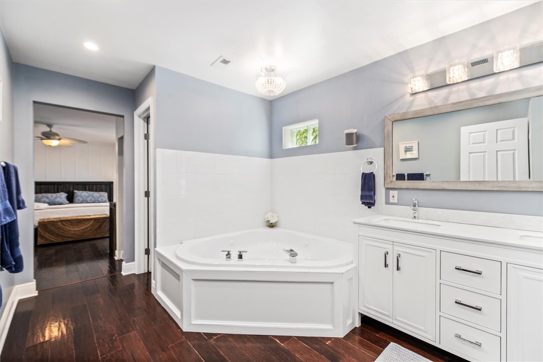 Corner soaking jetted  tub with white tiled surrou