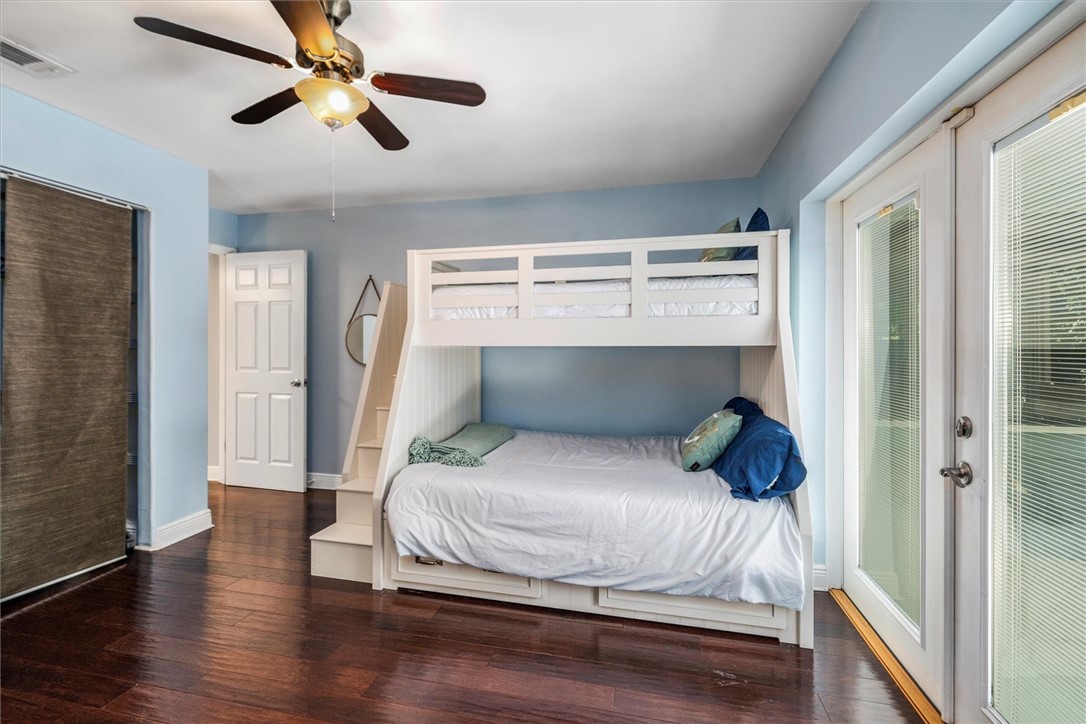 3rd bedroom with doors leading out to tropical bac