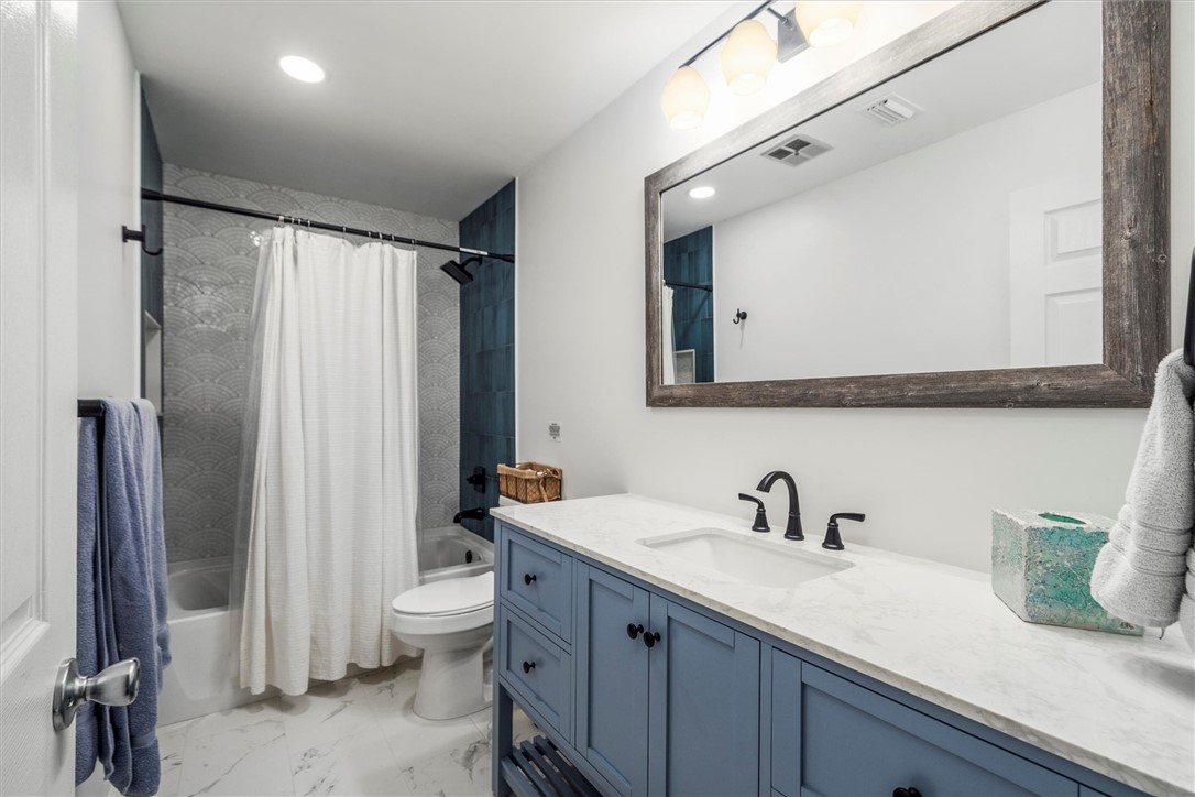 3rd Bathroom featuring a blue vanity with a white