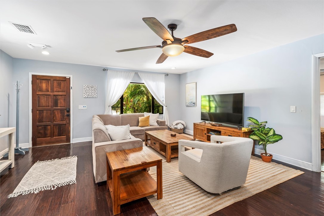 Living area featuring rich wood-finish flooring an