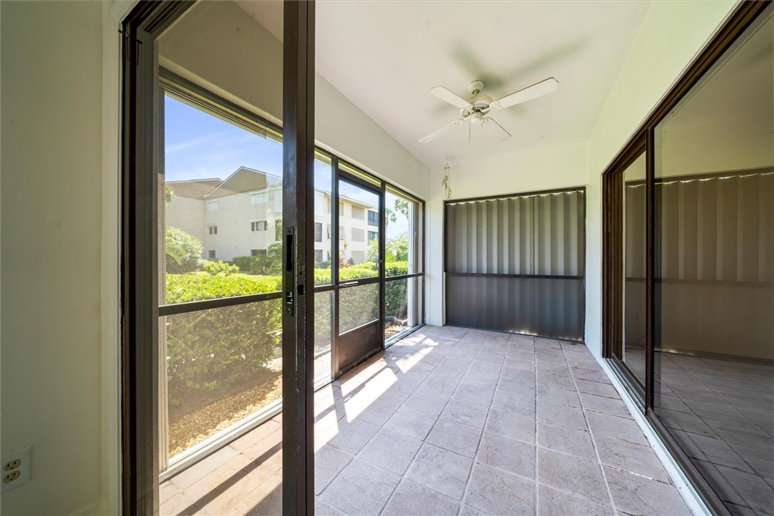 Screened lanai featuring tiled flooring and storm
