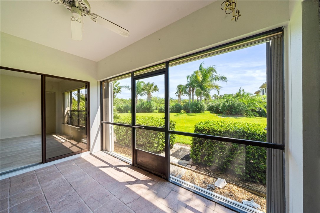 Screened patio with tile flooring and a ceiling fa