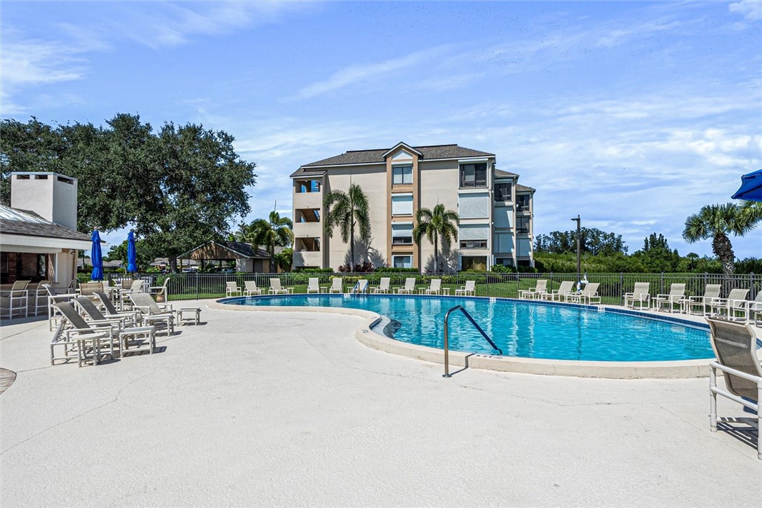 Resort-style heated swimming pool with lounge seat