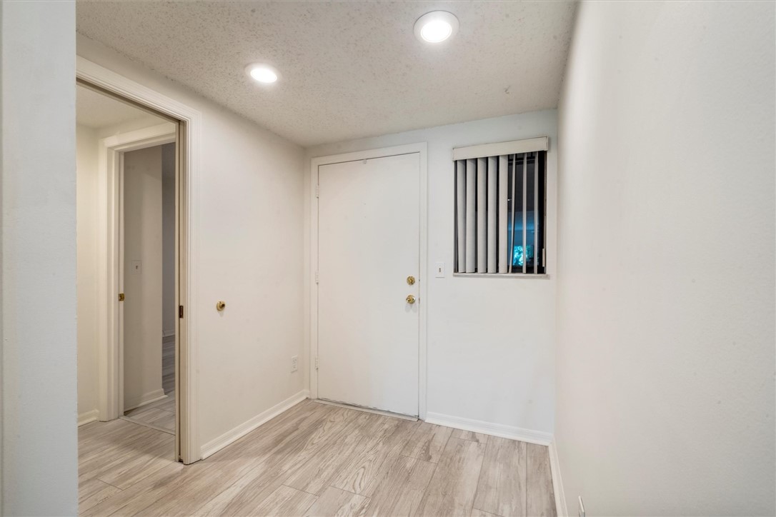 Entryway featuring light wood vinyl flooring,

