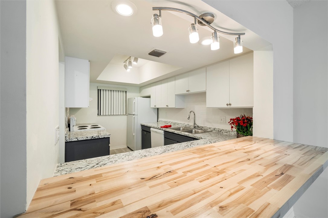 Kitchen featuring a wood-finish peninsula countert