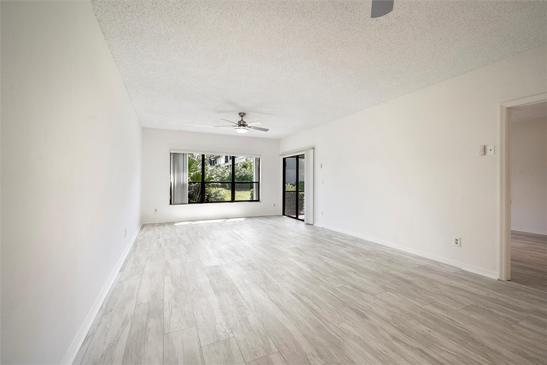 Spacious living room featuring light wood vinyl fl