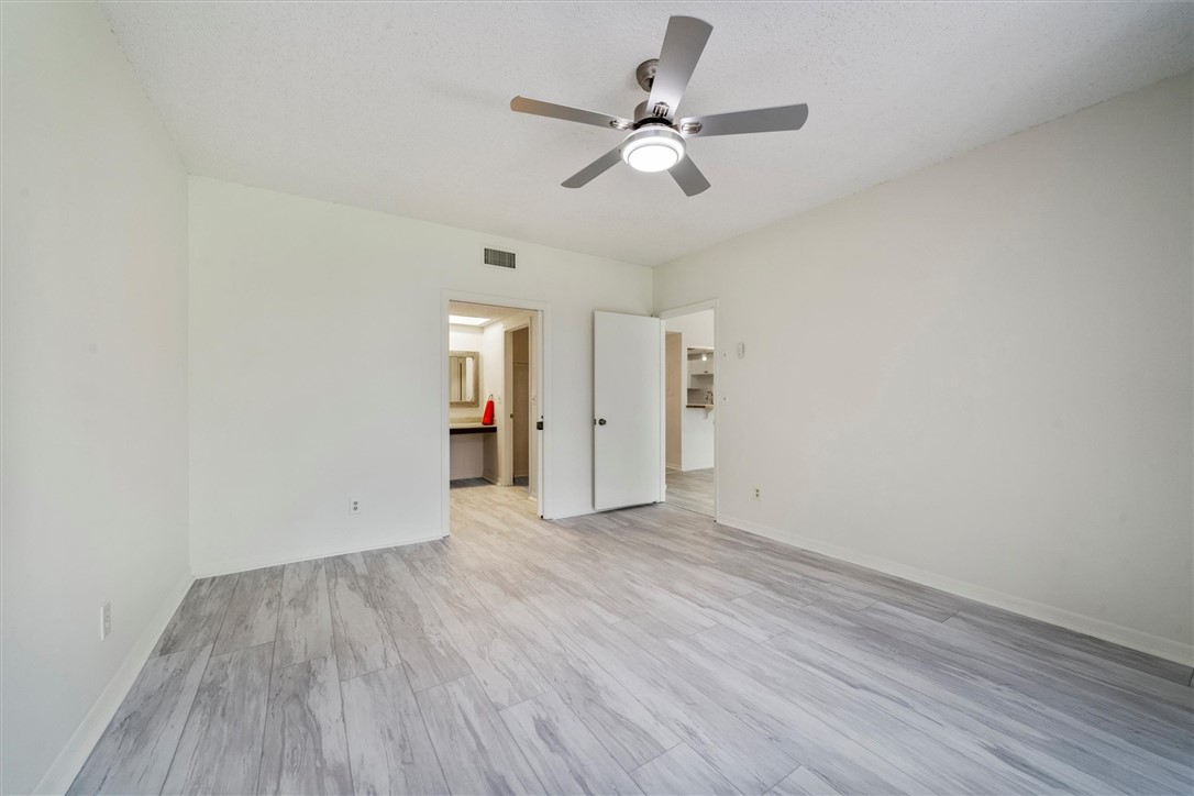 Spacious interior with neutral walls and plank-sty