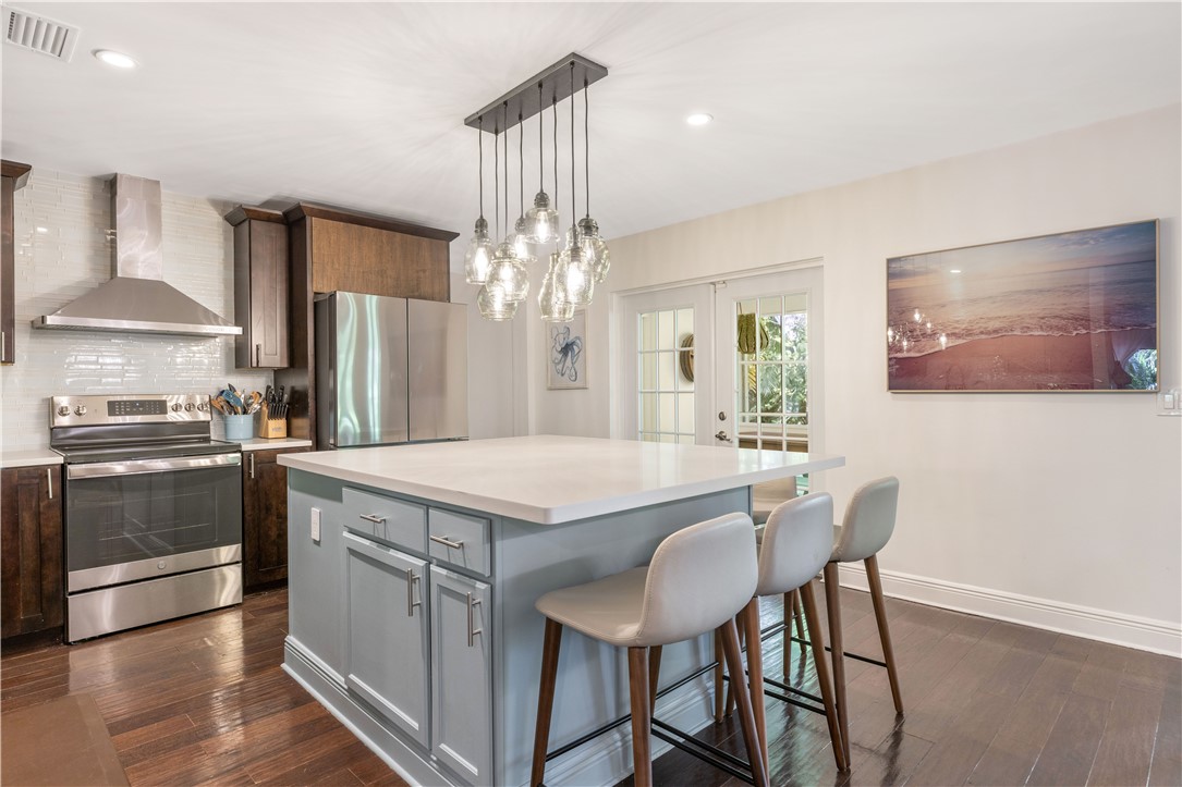 Modern kitchen featuring a light gray island with