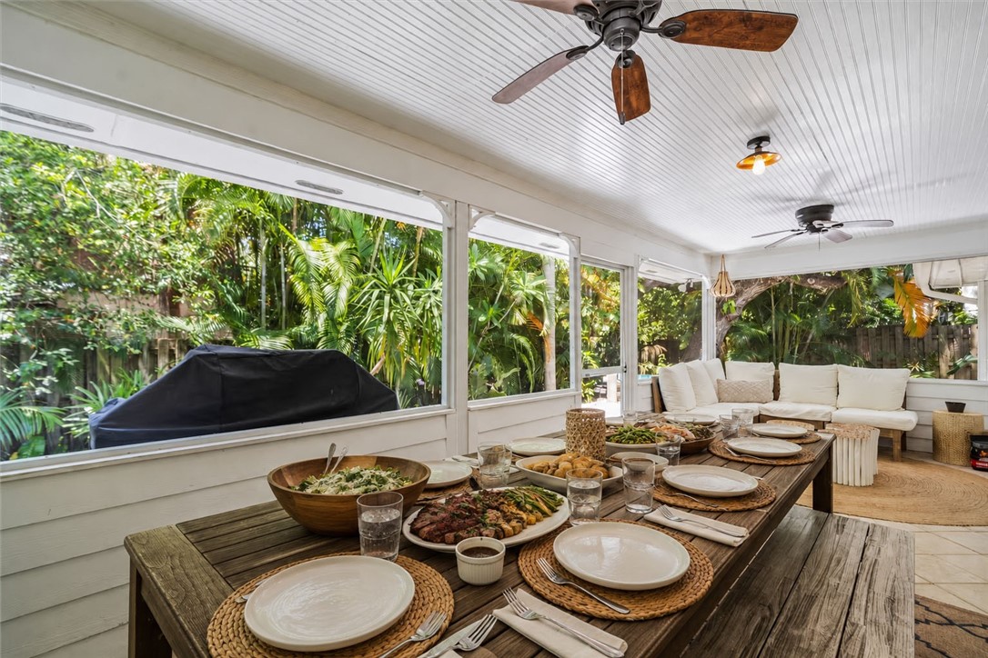 Screened-in outdoor living area featuring multiple