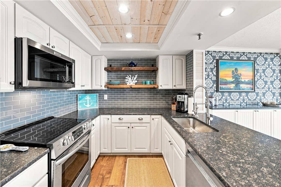 Kitchen featuring white cabinetry, gray patterned