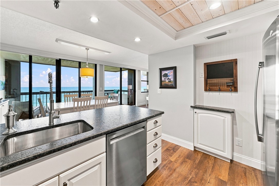 Kitchen with stainless steel appliances, dark ston