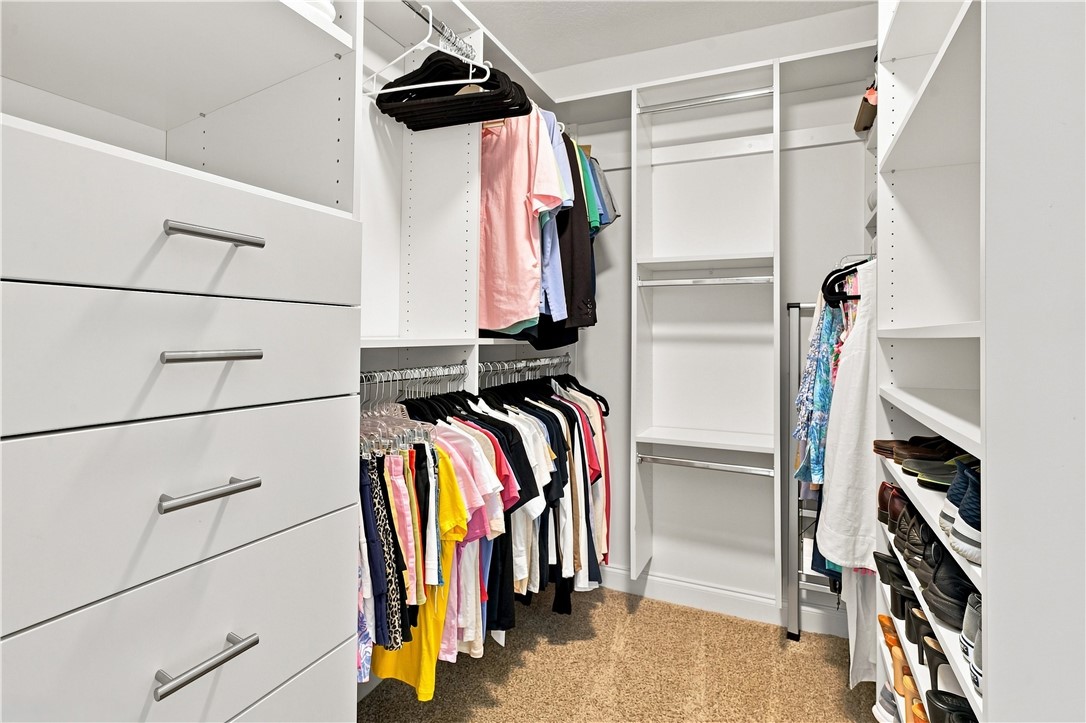 Large Custom Built-in closet featuring multiple dr