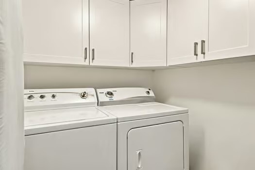 Laundry room with Upper cabinetry with a white fin